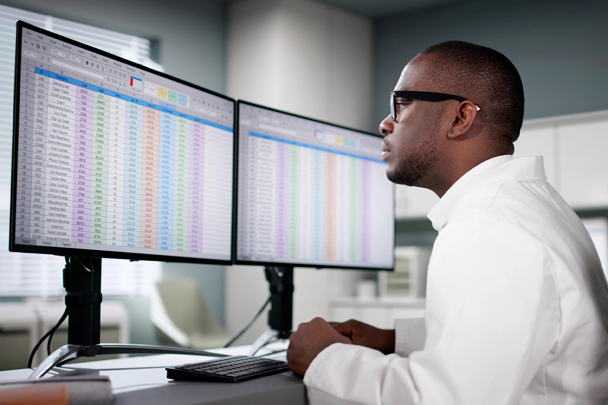 Specialist analyzing spreadsheets for CPT coding and review at the medical coding company Independent Practice Partners