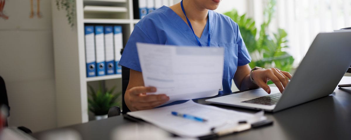 doctor working on medical billing practices to avoid fraud