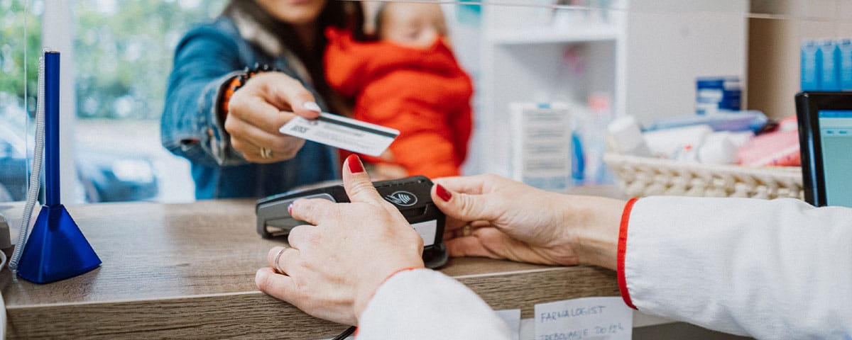 woman paying for her medical bill at her doctor's office