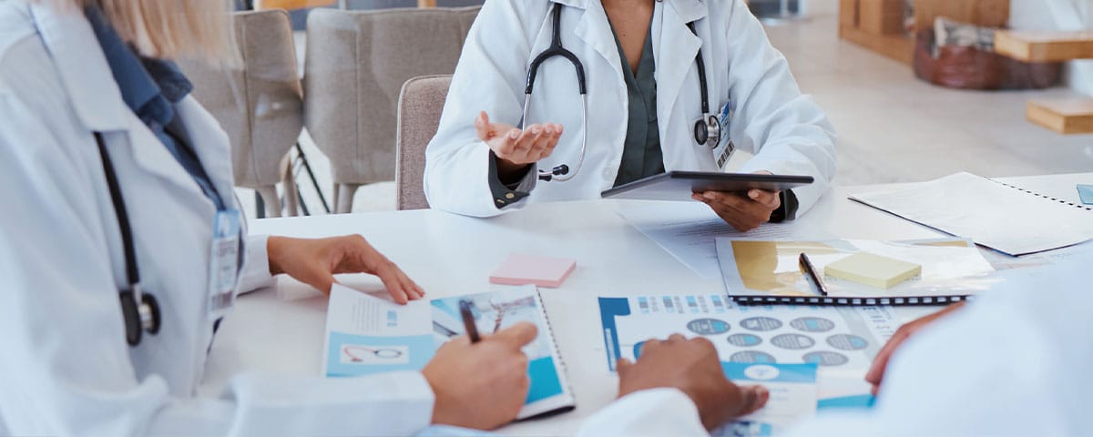 doctors at a table discussing medical coding