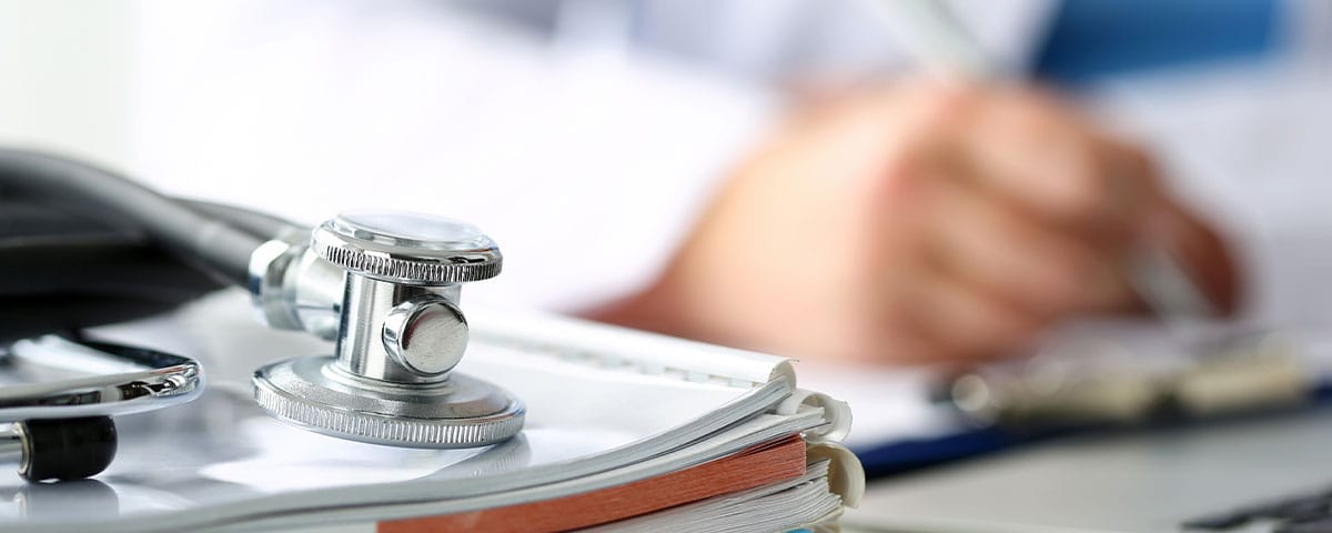 doctor working on patient documentation for their medical billing