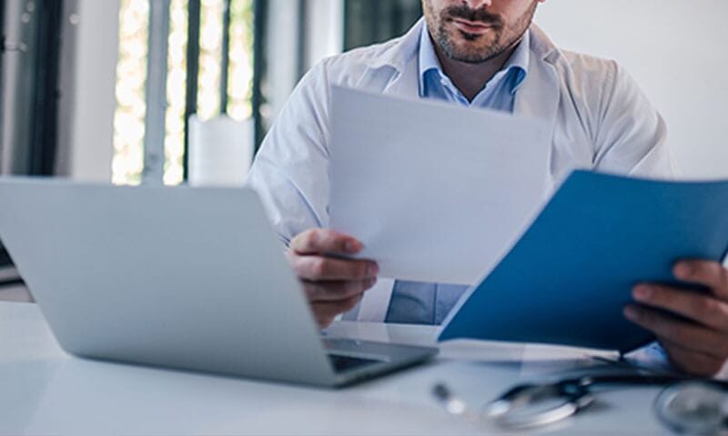 doctor reviewing the medical billing workflow for his practice