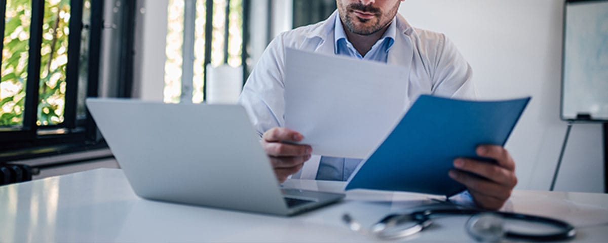 doctor reviewing the medical billing workflow for his practice