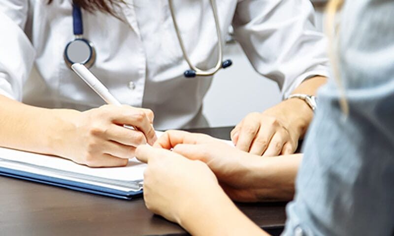 doctor filling out the billing information for a new patient in Long Island, NY