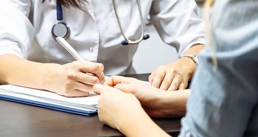 doctor filling out the billing information for a new patient