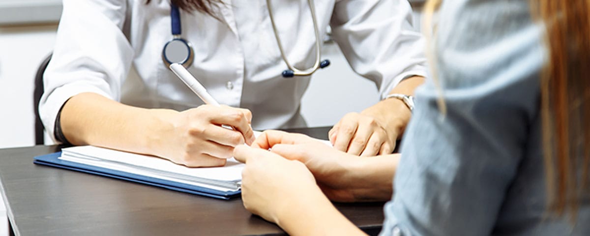 doctor filling out the billing information for a new patient in Long Island, NY