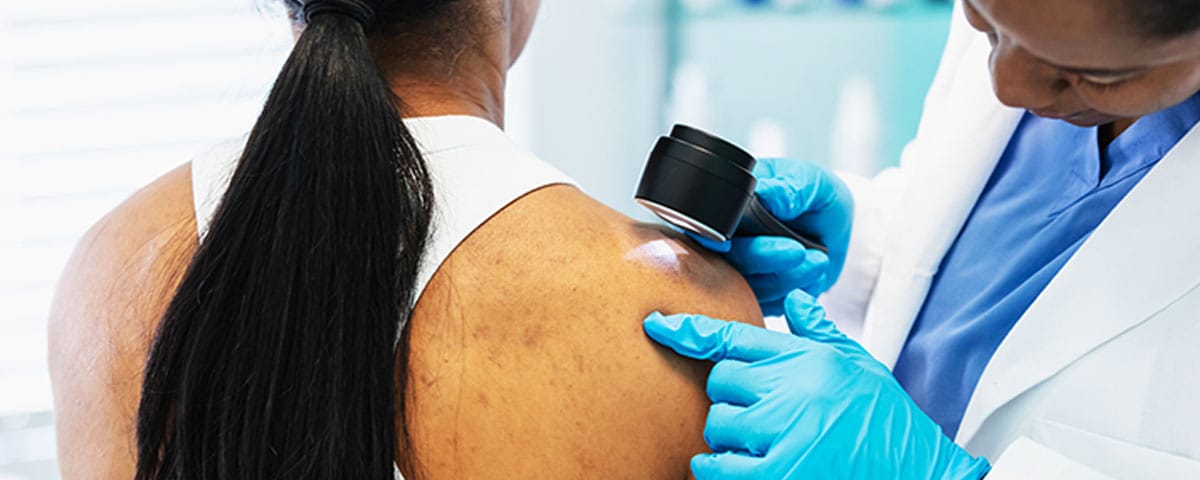 patient getting her skin checked by a dermatologist