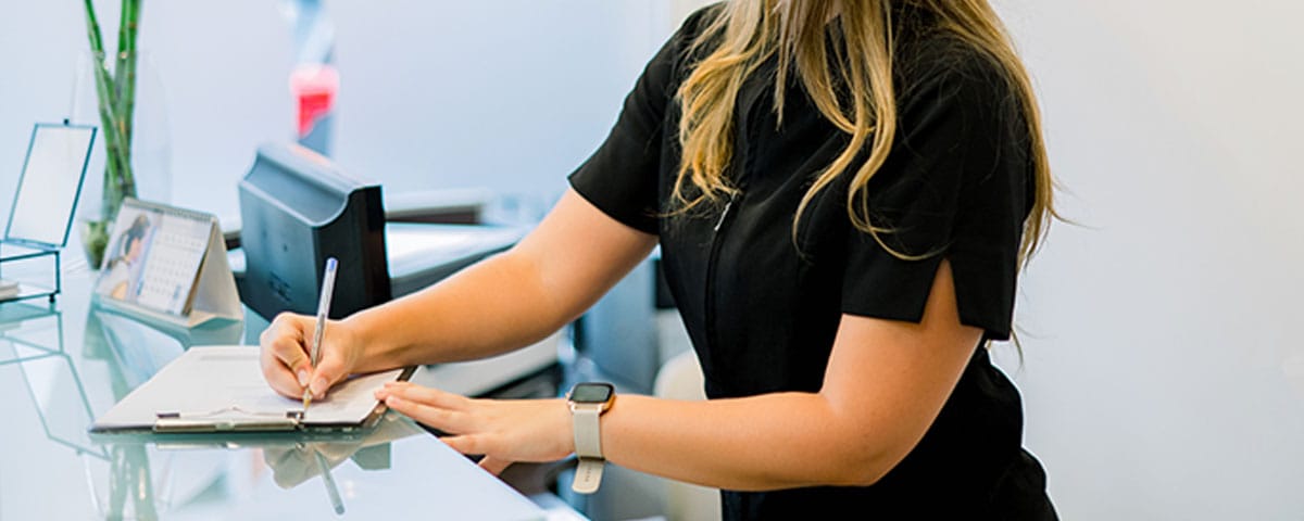 plastic surgeon filling out medical billing paperwork